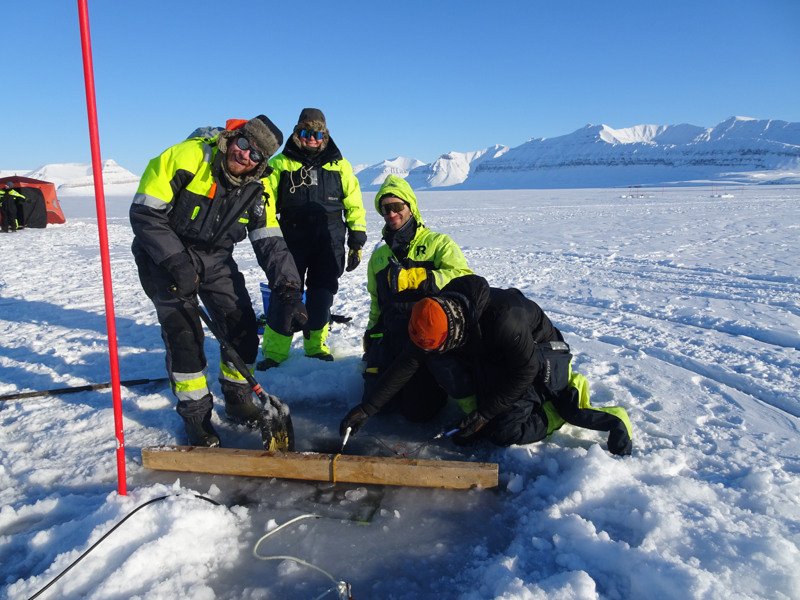 Sea ice measurements in Ekmanfjorden along with temperature, salinity, and ocean currents from instruments hanging beneath the ice. This year, we also measured CO₂ fluxes through the sea ice and in the water below. Photo: Pernille Ottosen