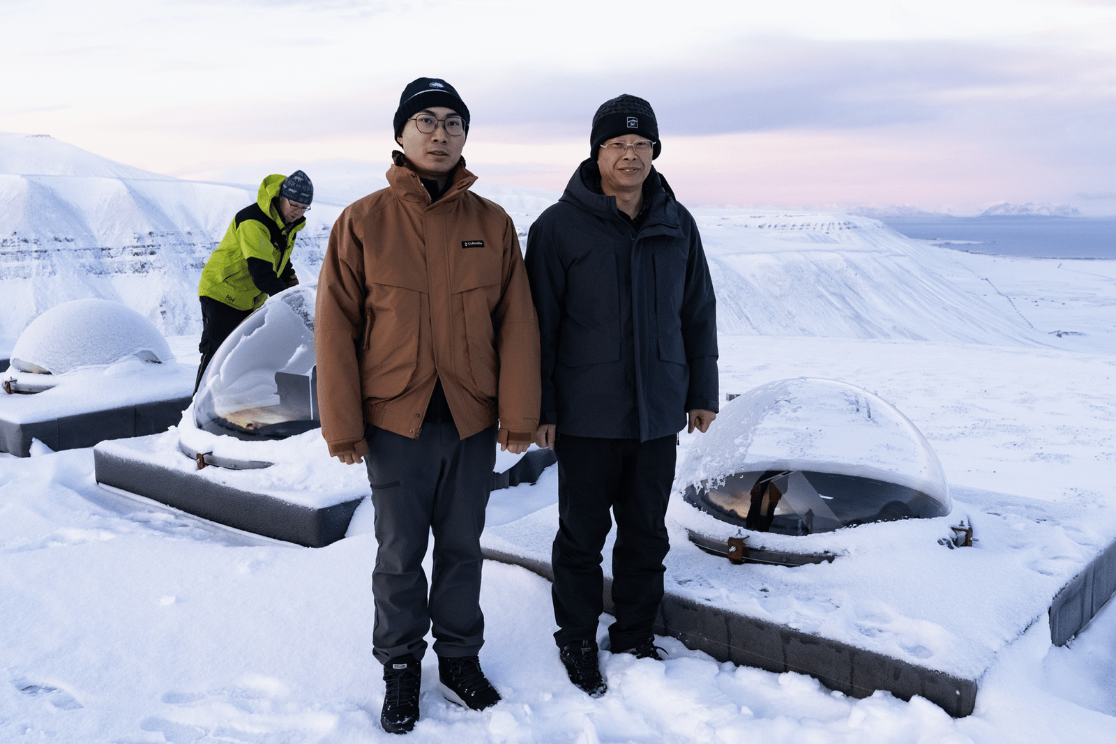 Prof. Huang with his companion, Peng Xiao, a PhD candidate from University of Science and Technology of China. PRIC's optical instrument under the dome observes the auroral emissions, which reveal the composition of the northern lights. Photo by: Ingrid Ballari Nilssen